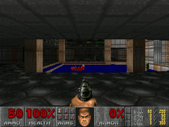 A screenshot of the start of the first level of Doom, for DOS. From a first-person perspective we see a hand clutching a pistol, aiming warily into the darkness of a troubled science facility on Phobos. A dead body can be seen in the distance.